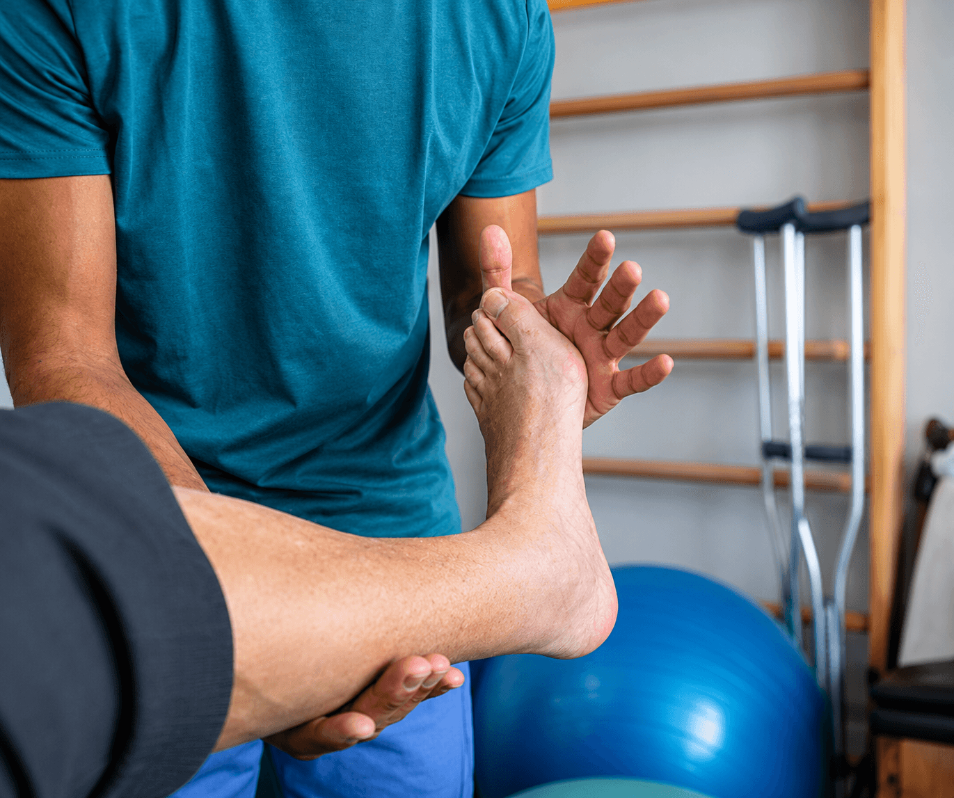 Therapist guiding a client through a rehab exercise