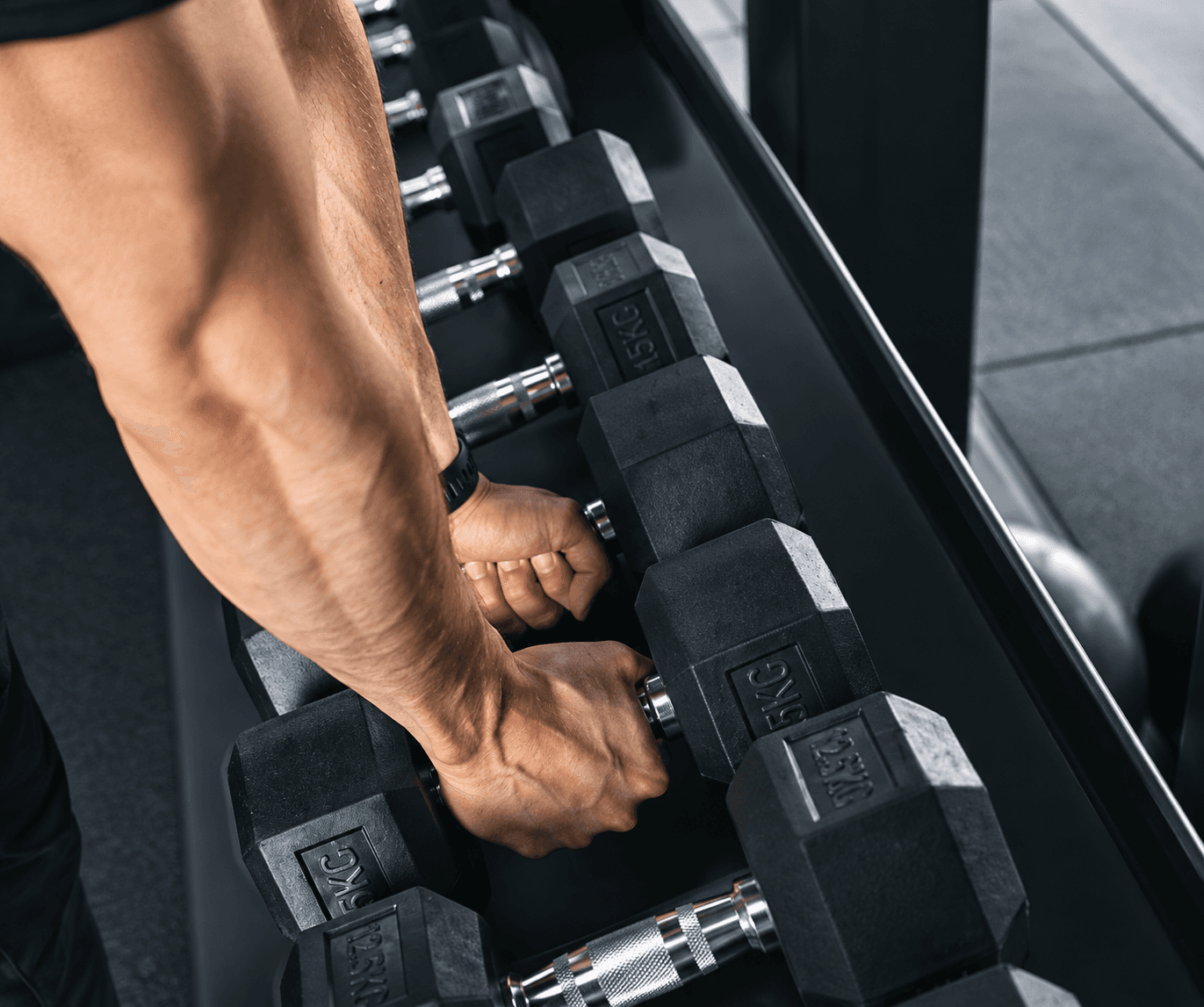 Trainer coaching a client on a cable machine